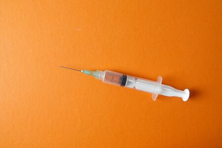 Medical concept with syringe for vaccination isolated on yellow background.の写真素材