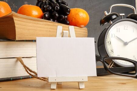 Medical concept with clock,books and stethoscope over rustic black background.の写真素材