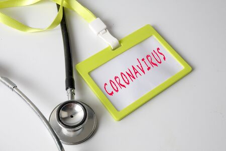 Medical Concept: Stethoscope and ID tag with inscription CORONAVIRUS.
