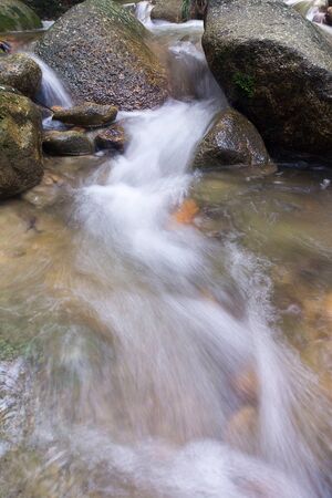 Waterfall/stream in a deep rain forest.の写真素材