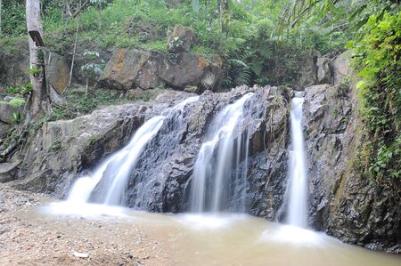 Waterfall/stream in a deep rain forest.の写真素材