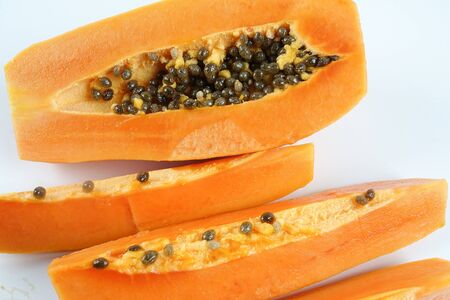 Half and slices papaya isolated on white.の写真素材