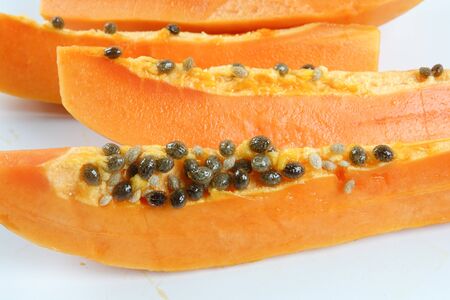 Half and slices papaya isolated on white.の写真素材