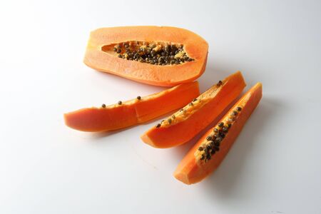 Half and slices papaya isolated on white.の写真素材