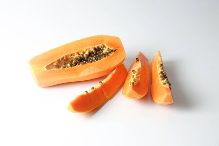 Half and slices papaya isolated on white.の写真素材