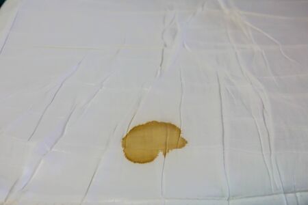 Bed sheet with period blood spot stains. Need to be cleaning.の写真素材