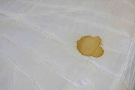 Bed sheet with period blood spot stains. Need to be cleaning.の写真素材