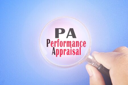 Hand holding magnify glass and PA, acronyms business conceptの写真素材