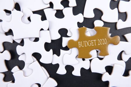 Budget 2020 printed on gold puzzle over white puzzle backgroundの写真素材