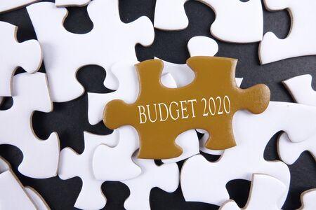 Budget 2020 printed on gold puzzle over white puzzle backgroundの写真素材