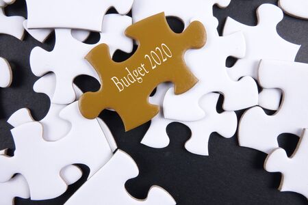Budget 2020 printed on gold puzzle over white puzzle backgroundの写真素材