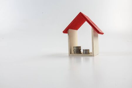 Housing/property concept with small red house isolated on white.の写真素材