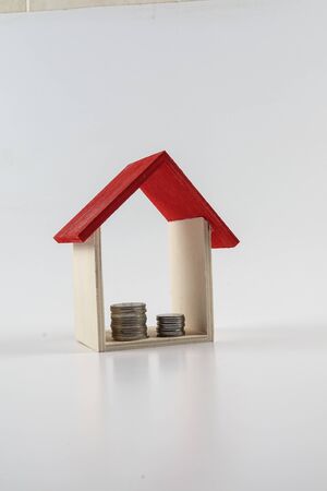 Housing/property concept with small red house isolated on white.の写真素材