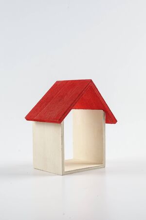 Housing/property concept with small red house isolated on white.の写真素材