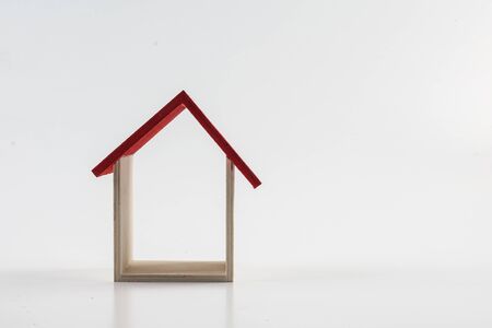 Housing/property concept with small red house isolated on white.の写真素材