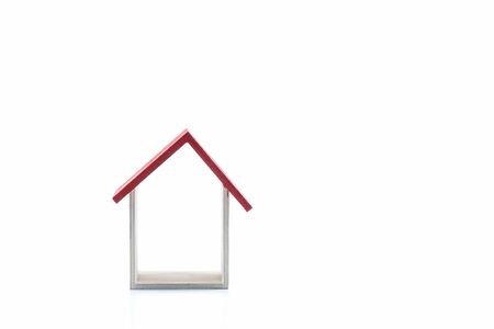 Housing/property concept with small red house isolated on white.の写真素材
