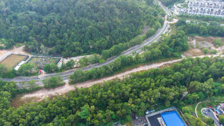 Aerial view of residential area with green asphalt road and residential houses directly above viewpoint. View of suburbs and city district. Real estate and housing market concept.の写真素材
