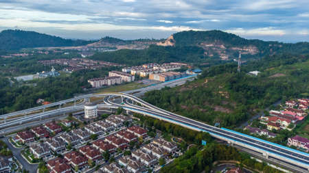 Aerial view of residential area with green asphalt road and residential houses directly above viewpoint. View of suburbs and city district. Real estate and housing market concept.の写真素材