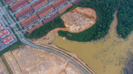Aerial view of residential area with green asphalt road and residential houses directly above viewpoint. View of suburbs and city district. Real estate and housing market concept.の写真素材