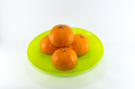 Oranges in green bowl on white backgroudの写真素材