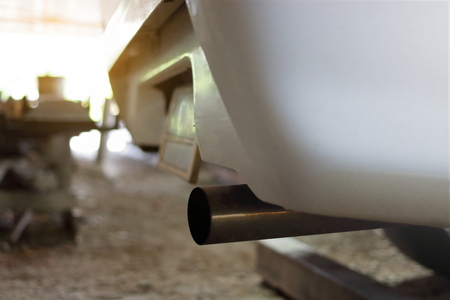 Close up exhaust pipe of car, shallow depth of field, sunshine effectの写真素材