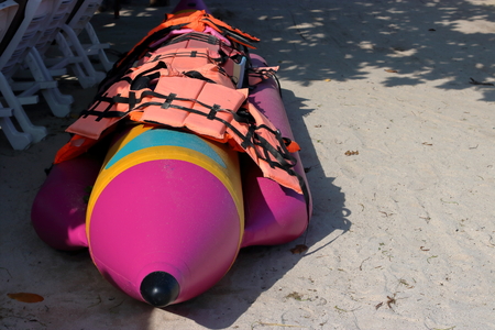 Banana boat and safety life jacket on the beachの写真素材