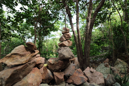 The pyramid of pebble stones on the nature background,shallow depth of field,light and shadowの写真素材