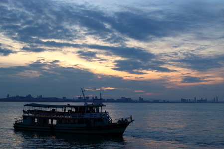 Silhouette of a passenger ferry boat during sunsetの写真素材