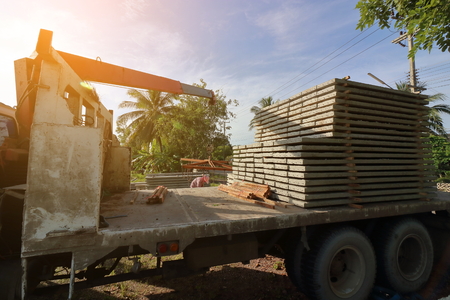 Sunshine effect, Stack of prestressed concrete slabs loaded on truck for constructionの写真素材
