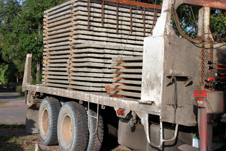 Stack of prestressed concrete slabs loaded on truck for construction, Side viewの写真素材
