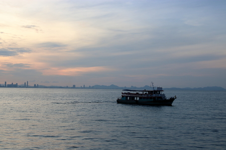 Silhouette of a passenger ferry boat during sunsetの写真素材