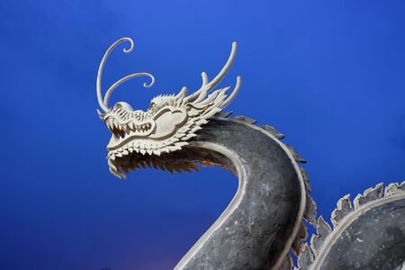 Chinese dragon on blue sky after sunsetの写真素材