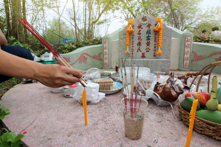Ratchaburi, Thailand - April 4, 2017 : Thai people praying Ancestor Worshipping with Sacrificial offering in the Qingming Festival at Jing Gung Cemeteryのeditorial素材
