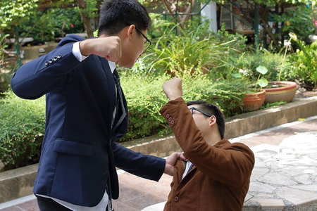 Angry businessman hit his rival in the parkの写真素材