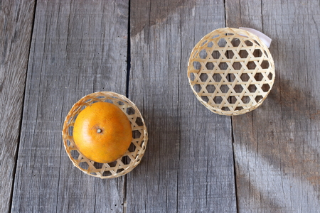 Top view of orange in a basket on old wooden board  background. Happy Chinese new year concept.の写真素材