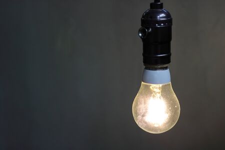 Close up one retro light lamp with copy space , bulb decorative in black background.
