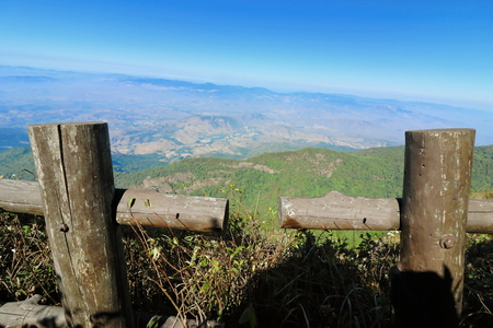 Close up wooden fence of Kew Mae Pan nature trail with mountain scenery background at Doi Inthanon , Chaing Mai , Thailandの写真素材