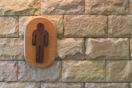 Sign of male toilet figure on textured marble wallの写真素材