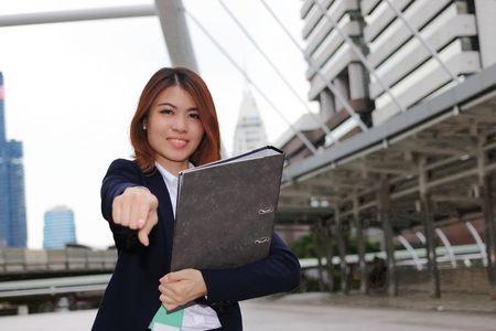 Leadership business female concept. Attractive young Asian businesswoman standing positive posing and looking at camera in outside office.の写真素材
