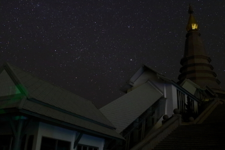 Pagoda buddhism on night stars on sky background.の写真素材