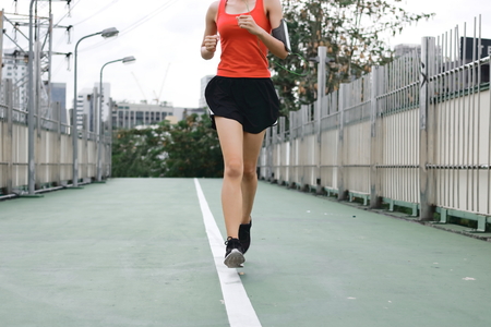 Woman's legs running exercise outdoors. Fitness and wellness concept.の写真素材