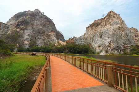 Beautiful walkway with rocky mountain background of khao Ngu Stone Park , Ratchaburi , Thailand.の写真素材