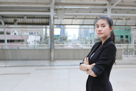 Confident young Asian business woman crossing one's arms at outside office.の写真素材
