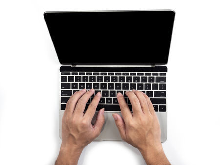 Top view of hands typing on computer laptop on white isolated background with clipping path.の写真素材