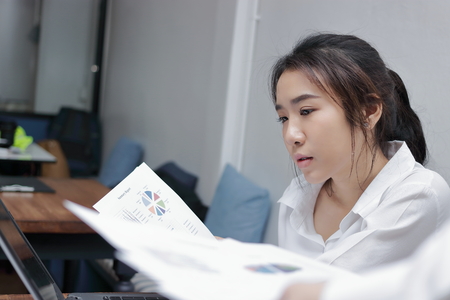 Close up attractive young Asian business woman working in office.