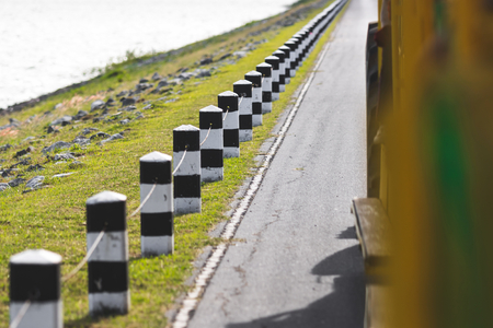 Black and white milestones on the road. Selective focus and shallow depth of field.の写真素材