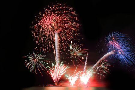 Festive colorful fireworks on night sky background. Celebratory holidayの写真素材
