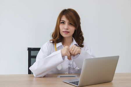 Young Asian female doctor sitting on workplace of hospital office.の写真素材