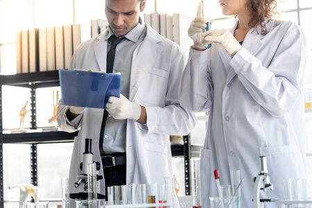 Two scientists working together in chemical laboratory.