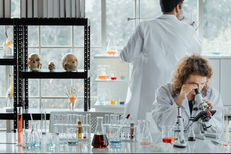 Two scientists working together in chemical laboratory.